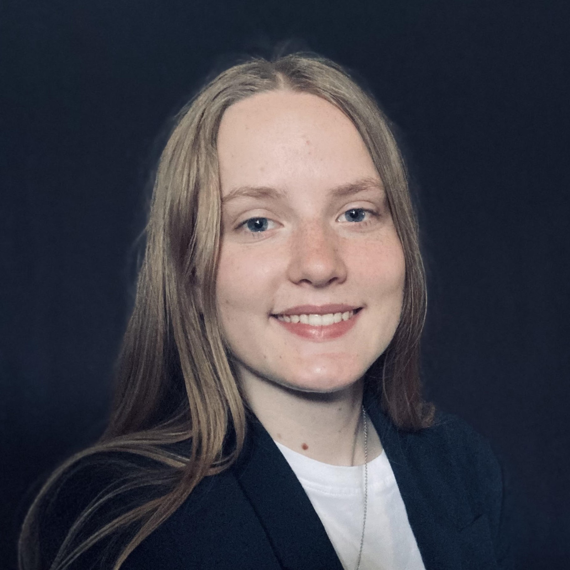 headshot of a woman wearing a suit, smiling